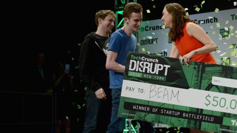 James Boehm and Matt Salsamendi accepting a check from Sam O'Keefe onstage during TechCrunch Disrupt NY 2016; photo by Noam Galai/Getty Images for TechCrunch