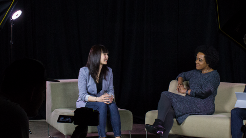 A photo of Amanda Phingbodhipakkiya and Microsoft employee Megan Carpenter talking to each other while sitting in chairs.