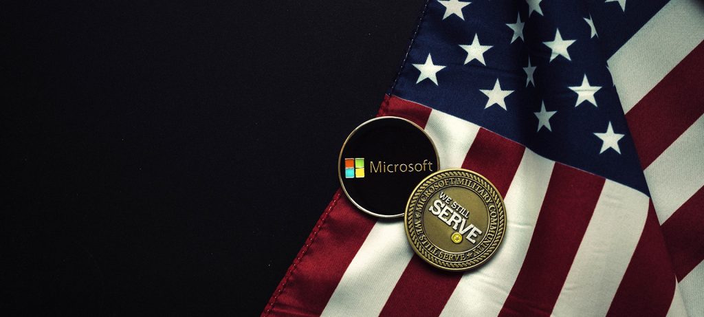US flag and coins that say 'We still serve' and the Microsoft logo