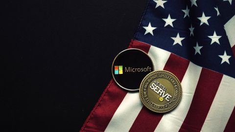 US flag and coins that say 'We still serve' and the Microsoft logo
