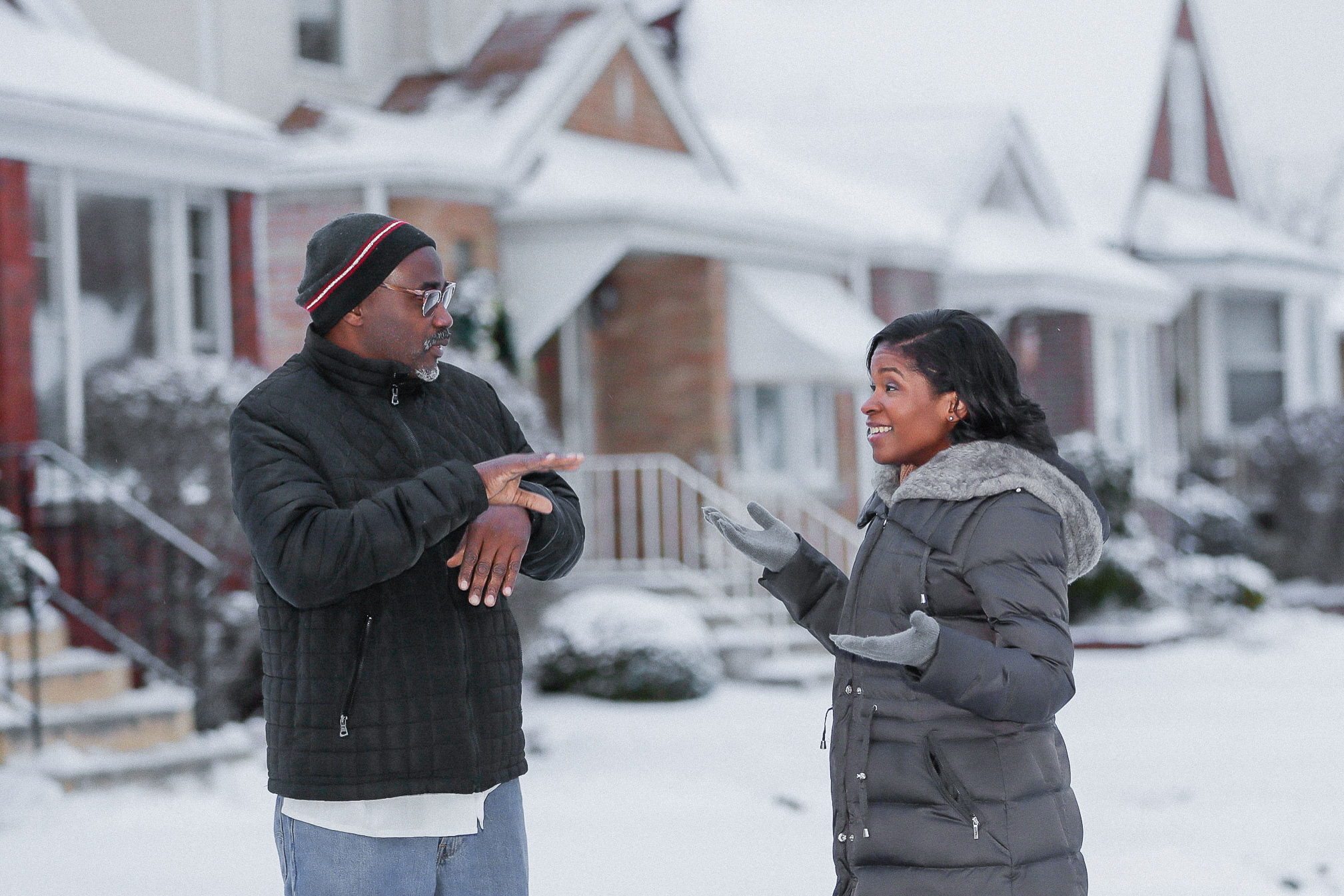 Royce Martin and Heather Dowdy having a conversation while standing in the snow outside their family home in Chicago.