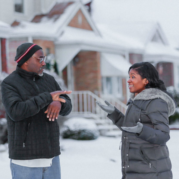 a photo of Royce Martin and Heather Dowdy having a conversation while standing in the snow outside their Chicago home.