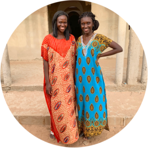 Two women pose in brightly colored dresses
