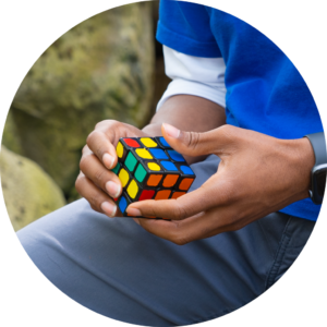 A close-up photo of a man holding a Rubik's cube