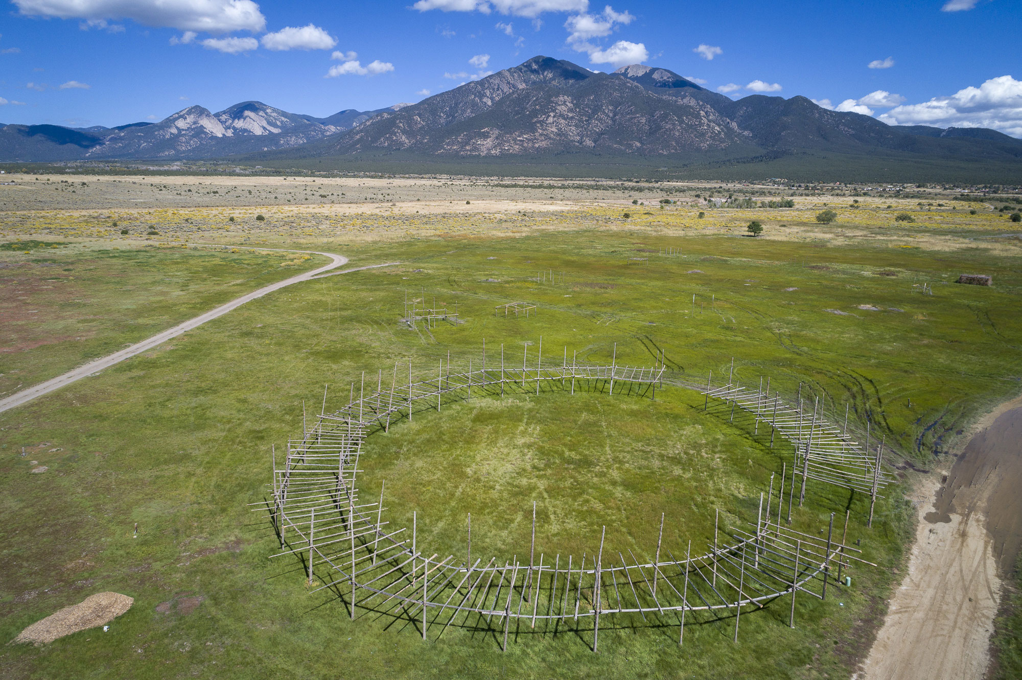 An ariel photograph of a round structure that serves as the Taos Pueblo powwow grounds