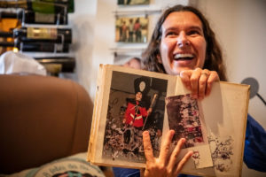 A woman showing an old photograph from a photo book