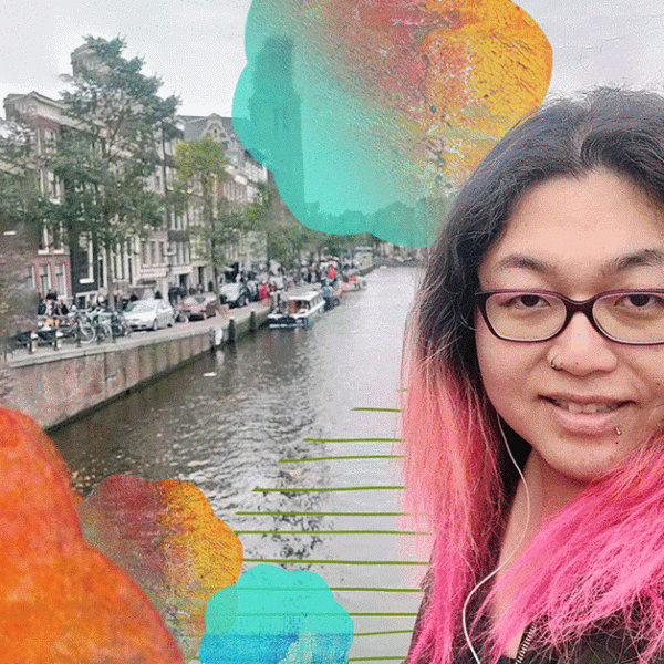 A woman with pink hair and glasses standing in front of a river. Text to the side reads "AAPI"