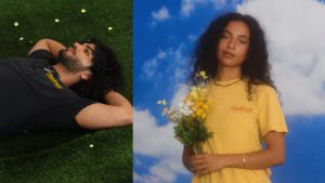 On the left, a man lays on grass wearing a black Hardware t-shirt, and on the right, a woman wears a yellow Hardwear t-shirt and holds a bouquet of flowers in front of a blue and white background.