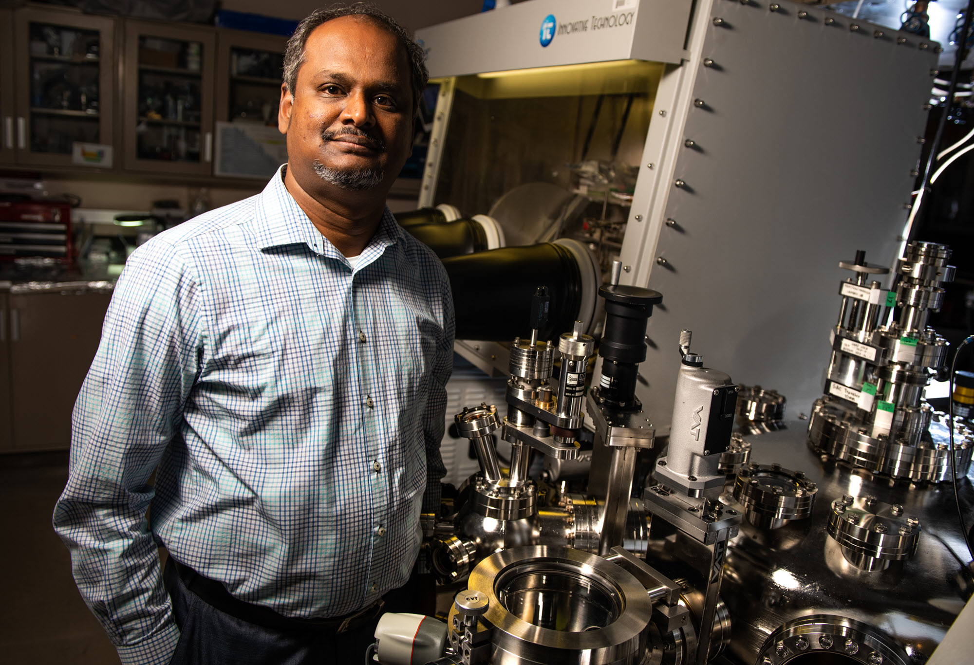 Portrait of Vijay Murugesan, material sciences group lead at Pacific Northwest National Laboratory, in the lab setting.