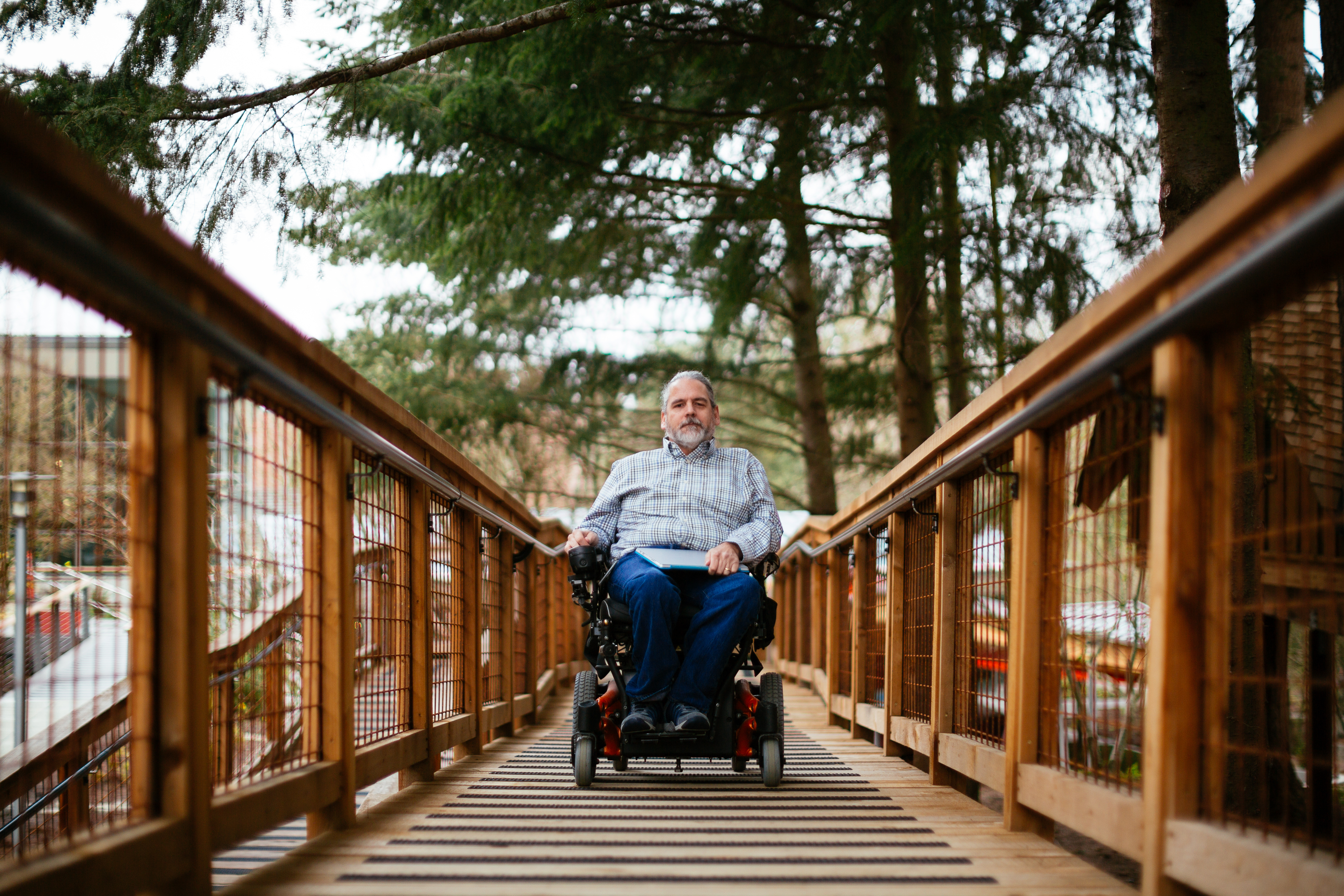 Man with wheelchair on wooden ramp