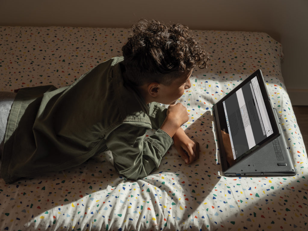 Un joven frente a una laptop