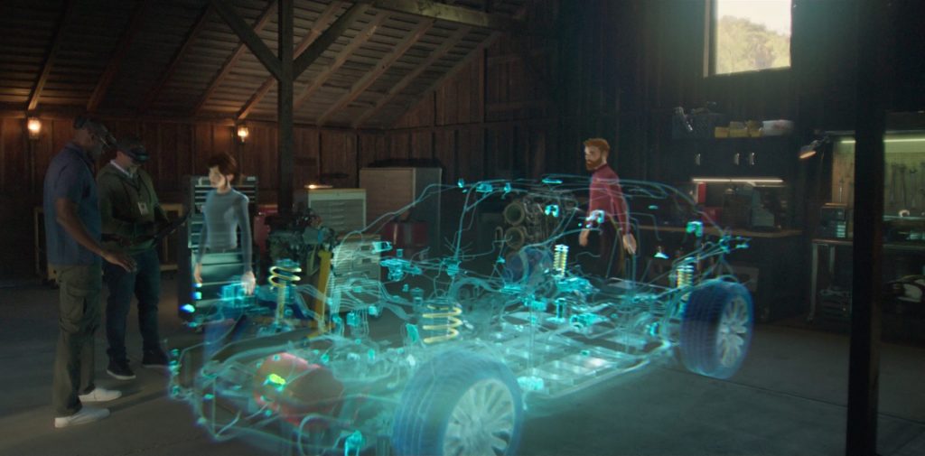 Los avatares aparecen alrededor de un holograma tridimensional de esquemas de automóviles para ilustrar una sesión de revisión de un diseño virtual en realidad mixta.