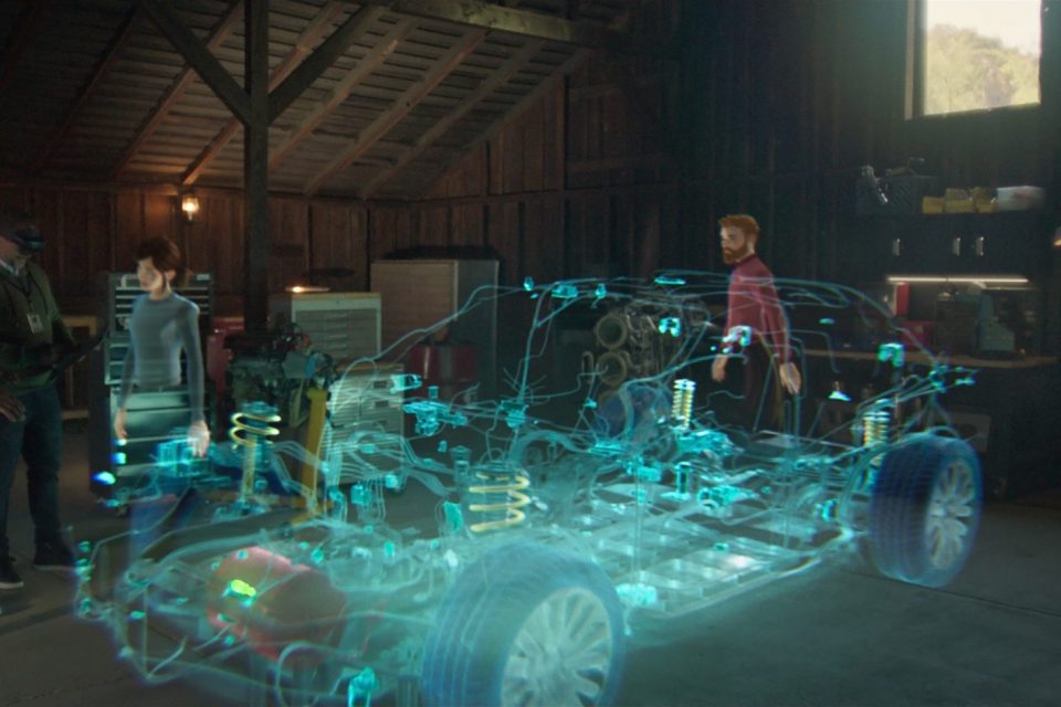 Los avatares aparecen alrededor de un holograma tridimensional de esquemas de automóviles para ilustrar una sesión de revisión de un diseño virtual en realidad mixta.