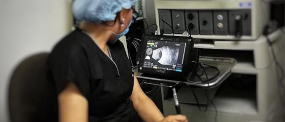 Una doctora frente a una máquina de ultrasonidos