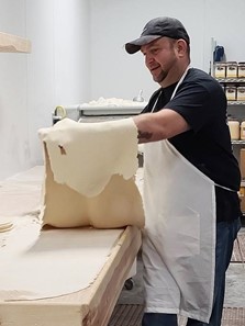 Juan Servín hace masa de pizza en el trabajo