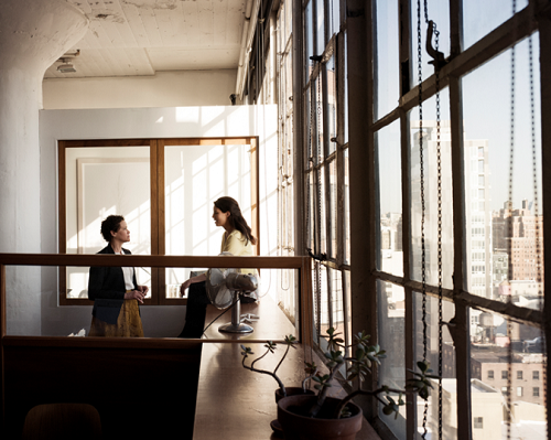 man and woman talink in office