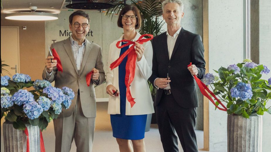 Judson Althoff, Catrin Hinkel and Ralph Haupter Cutting a red ribbon to officially open the MTC.