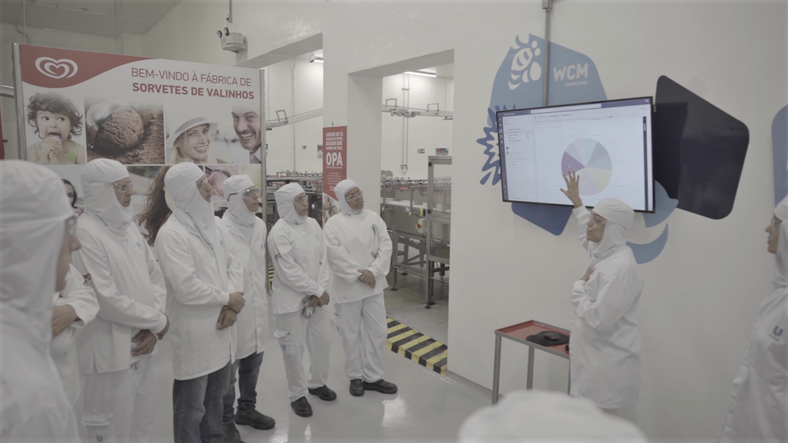 Funcionários observam tela com dados em fábrica da Unilever em Valinhos, Brasil.