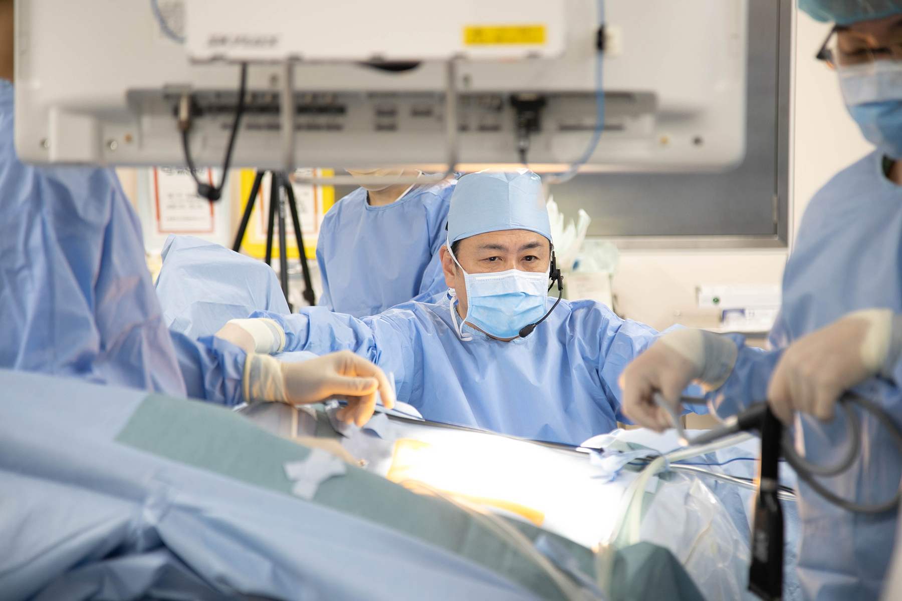 A doctor doing surgery with a team in an operating theater