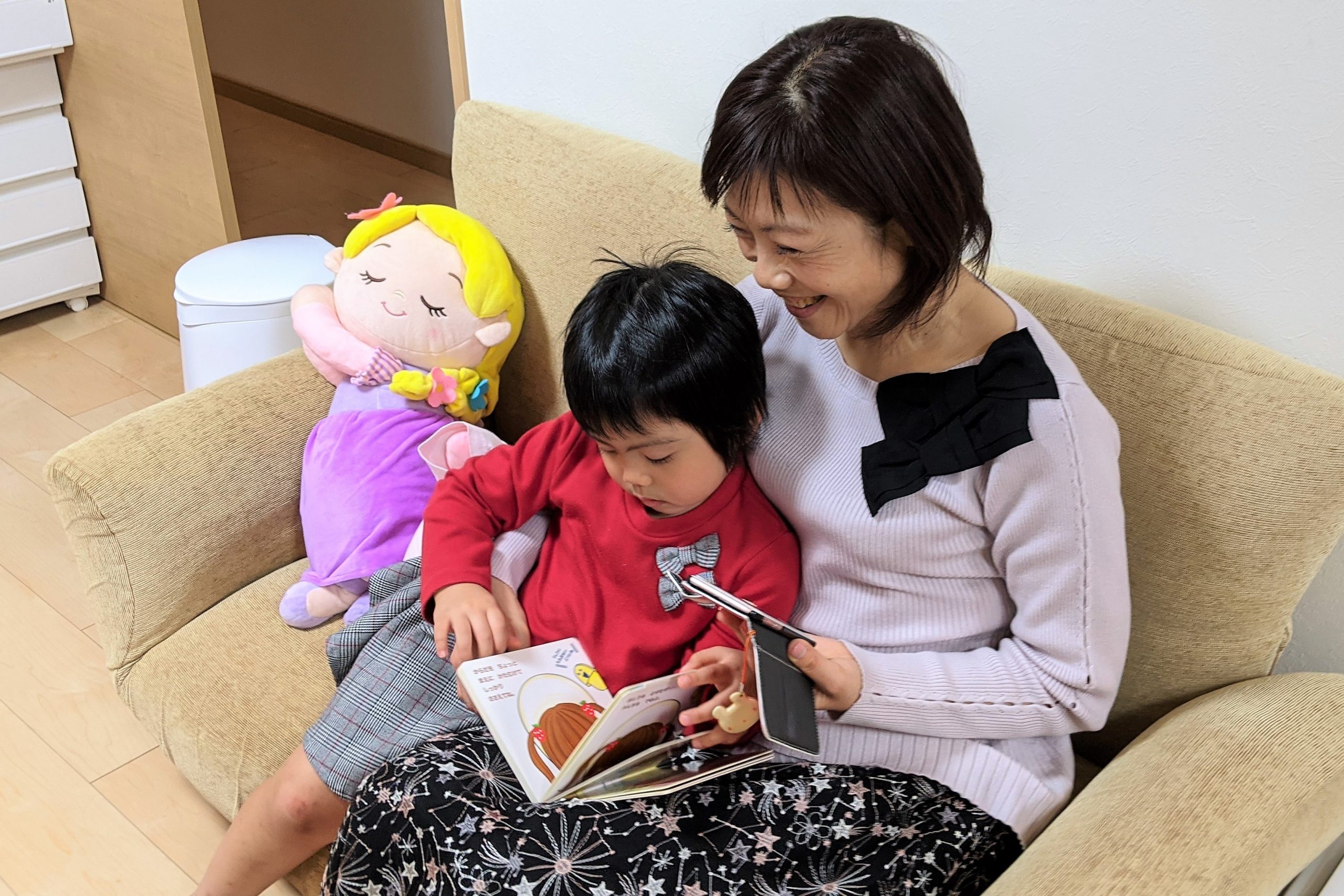 mother and young daughter reading a picture book