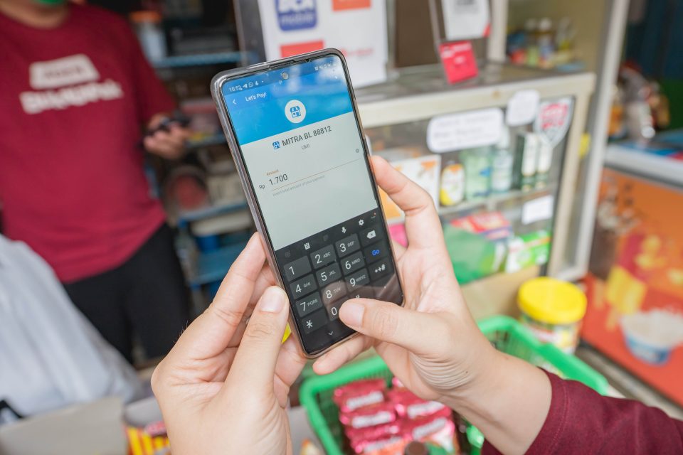 A person using their smartphone to make a money transfer