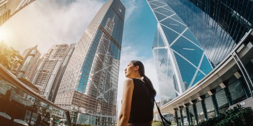 woman standing amongst skyscrapers