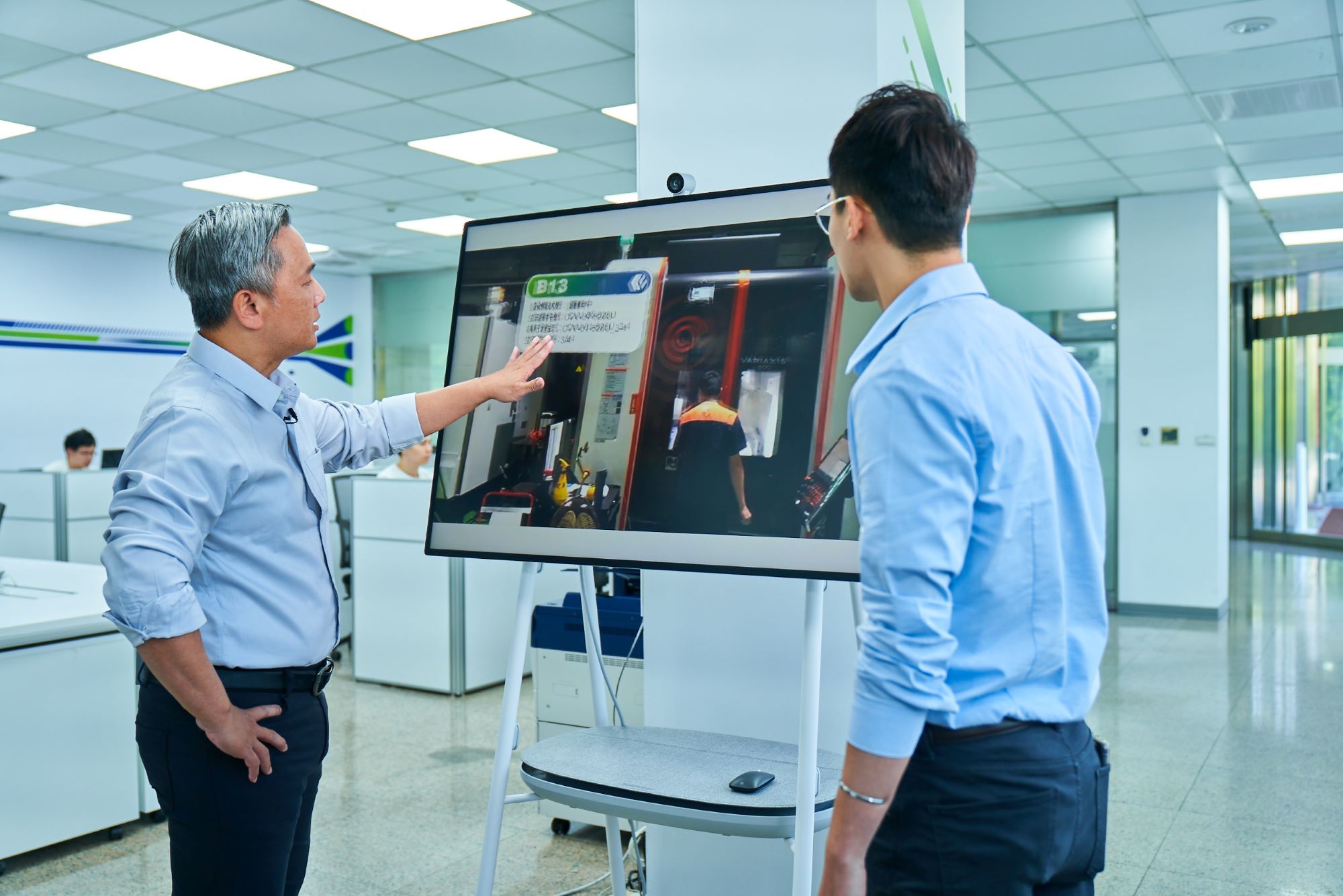 Two King Steel employees are shown using a Surface computer. 