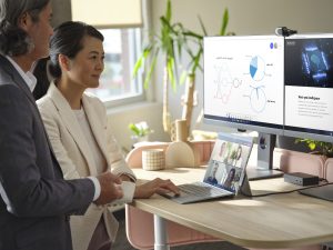 Man and woman working at a computer together