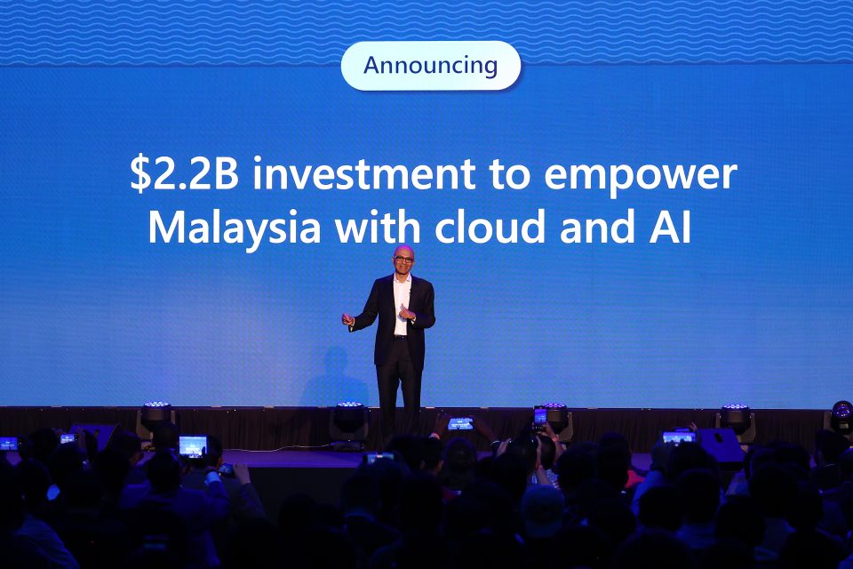 Man on stage making an investment announcement in Malaysia