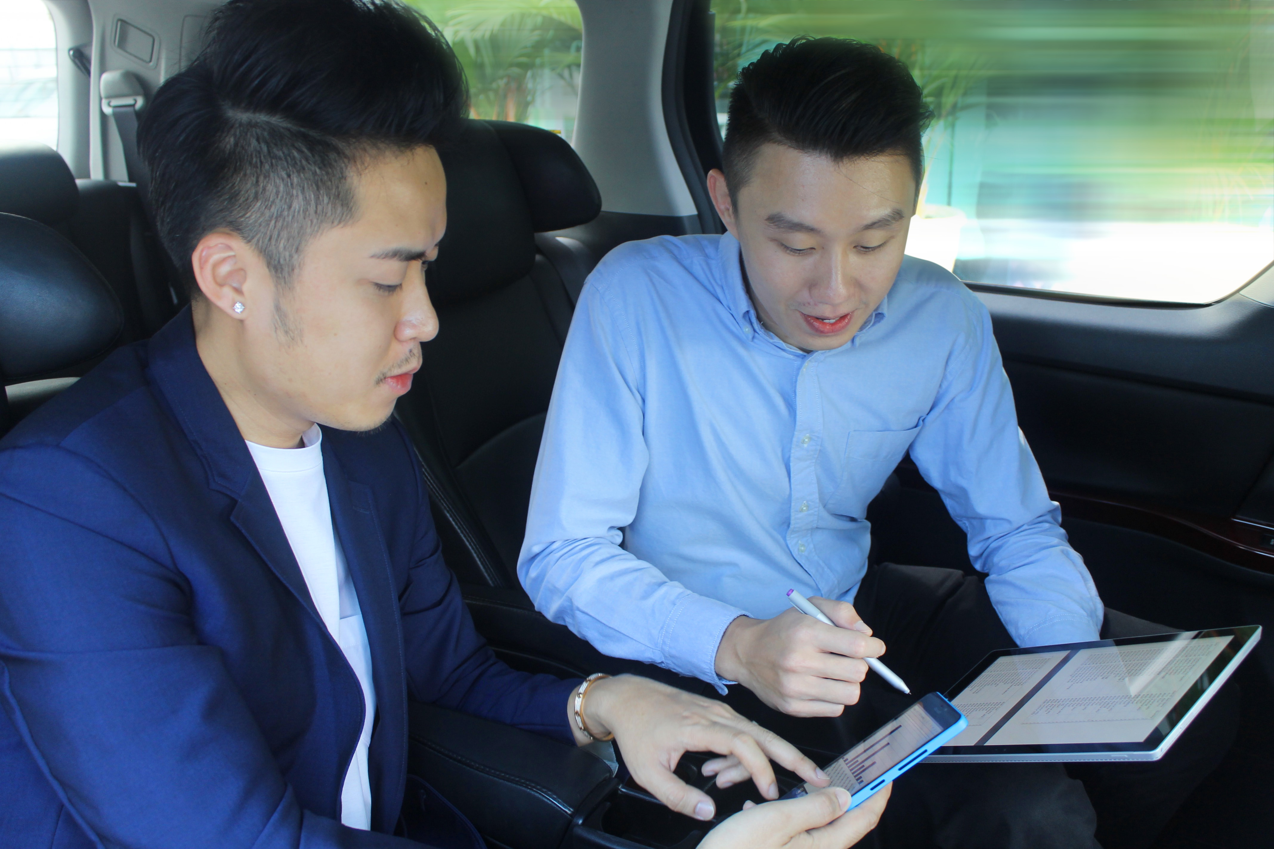Chatime's Technology and Operations Excellence Manager Howard Woon and Bryan Loo discussing strategies on the move, with the new POS system powered by Microsoft Windows and Azure