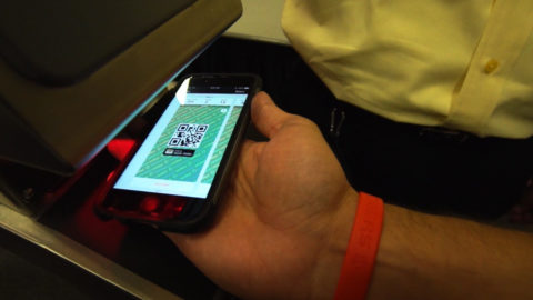 a picture of a phone scanning a mobile ticket.