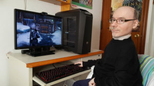 a guy sitting in front of a pc