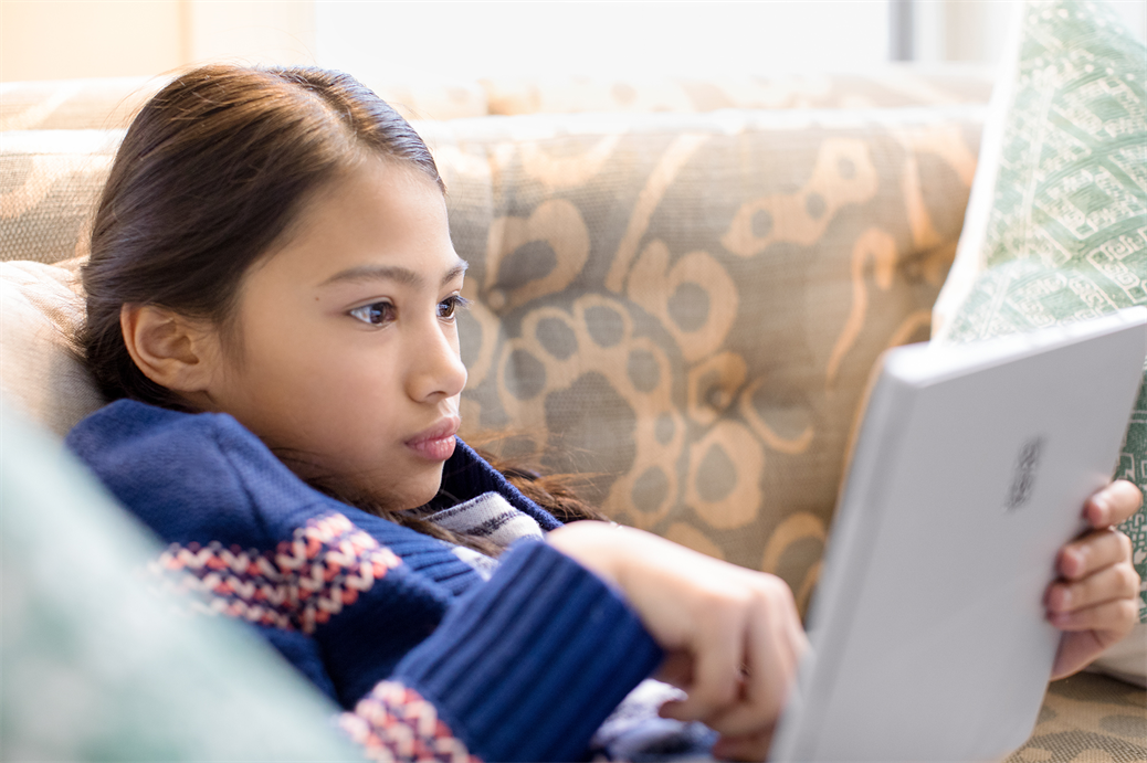 Female child using laptop in room