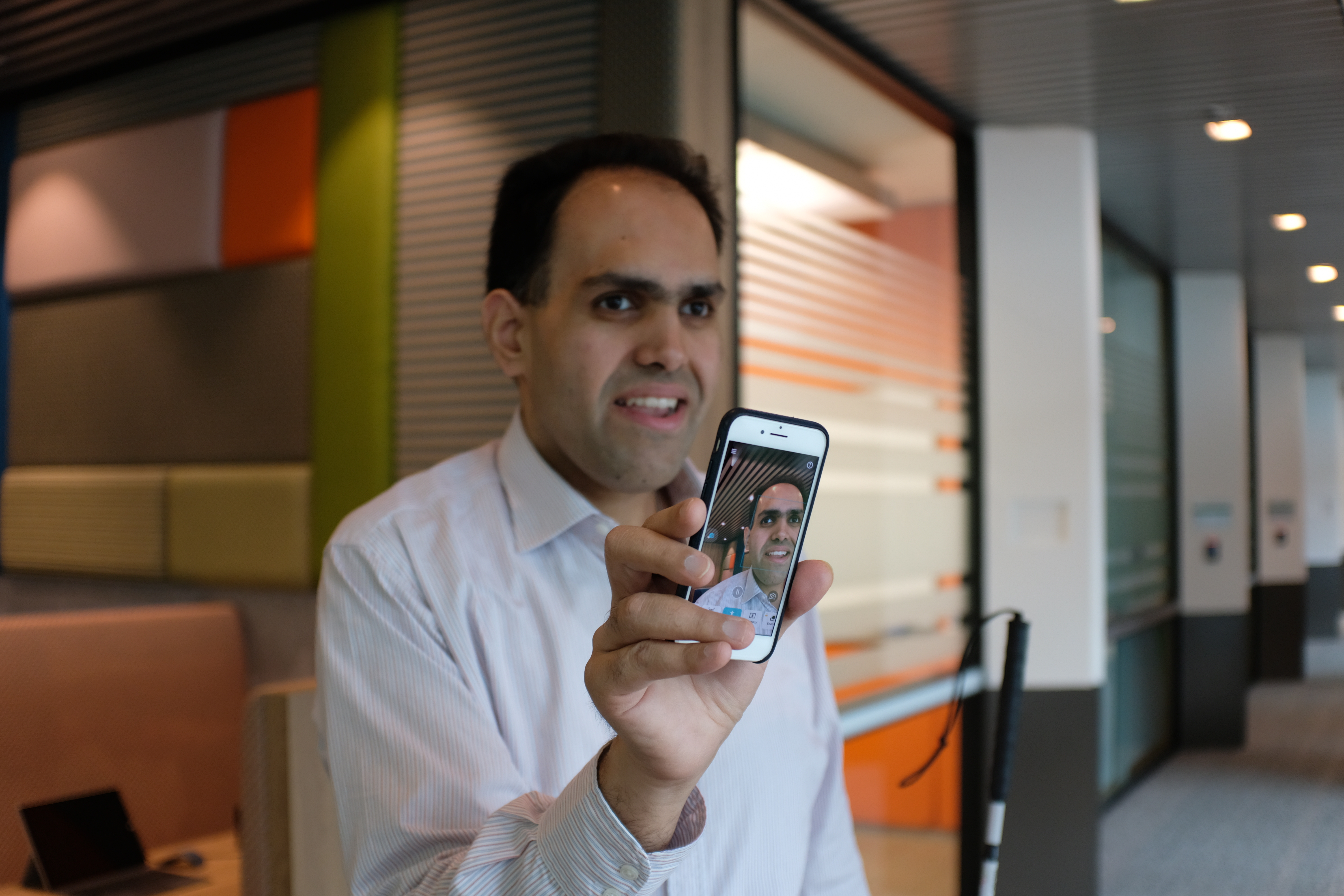 Saqib Shaikh demonstrates the Seeing AI app on his smartphone during a recent visit to Microsoft Asia’s headquarters in Singapore.