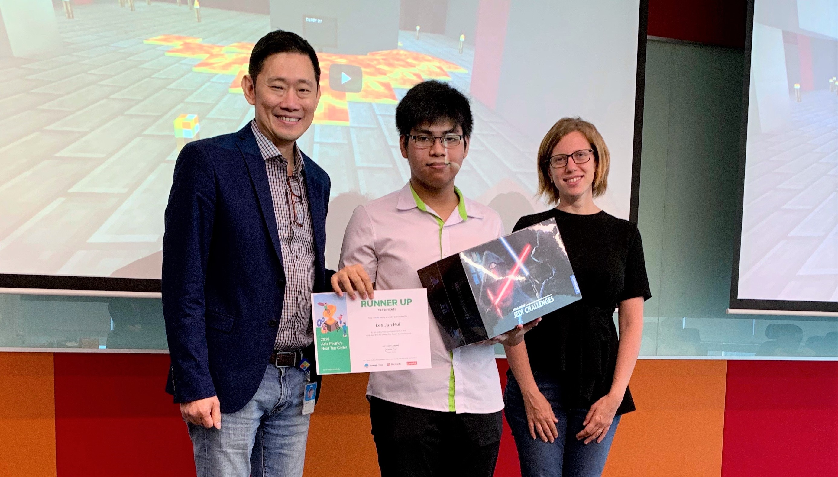 Kevin Wo, Managing Director, Microsoft Singapore (left) presenting the first runner-up prize to Singapore student, Lee Jun Hui (centre) for the Asia Pacific’s Next Top Coder competition, alongside Dr. Daiana Beitler, Philanthropies Director, Microsoft Asia