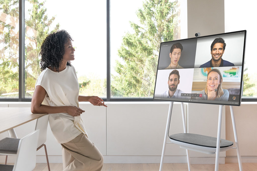Woman having a web cam conversation on Microsoft Teams on the Surface Hub 2S