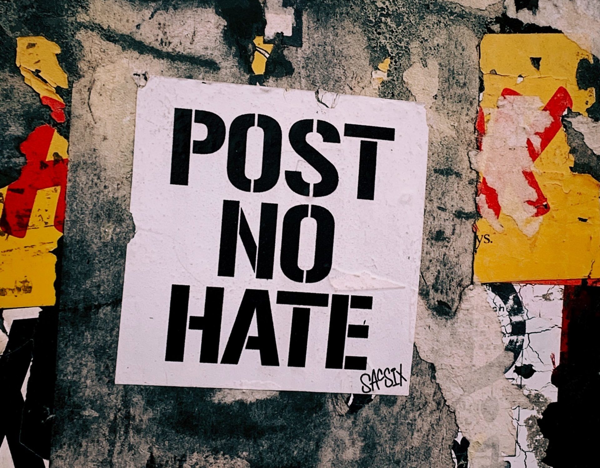 poster on wall with "Post no Hate" writing