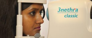 A woman looks into the 3Nethra retina scanning device
