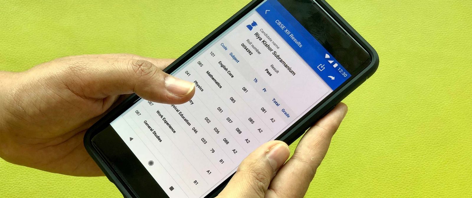 A close-up of a smartphone displaying CBSE board exam results