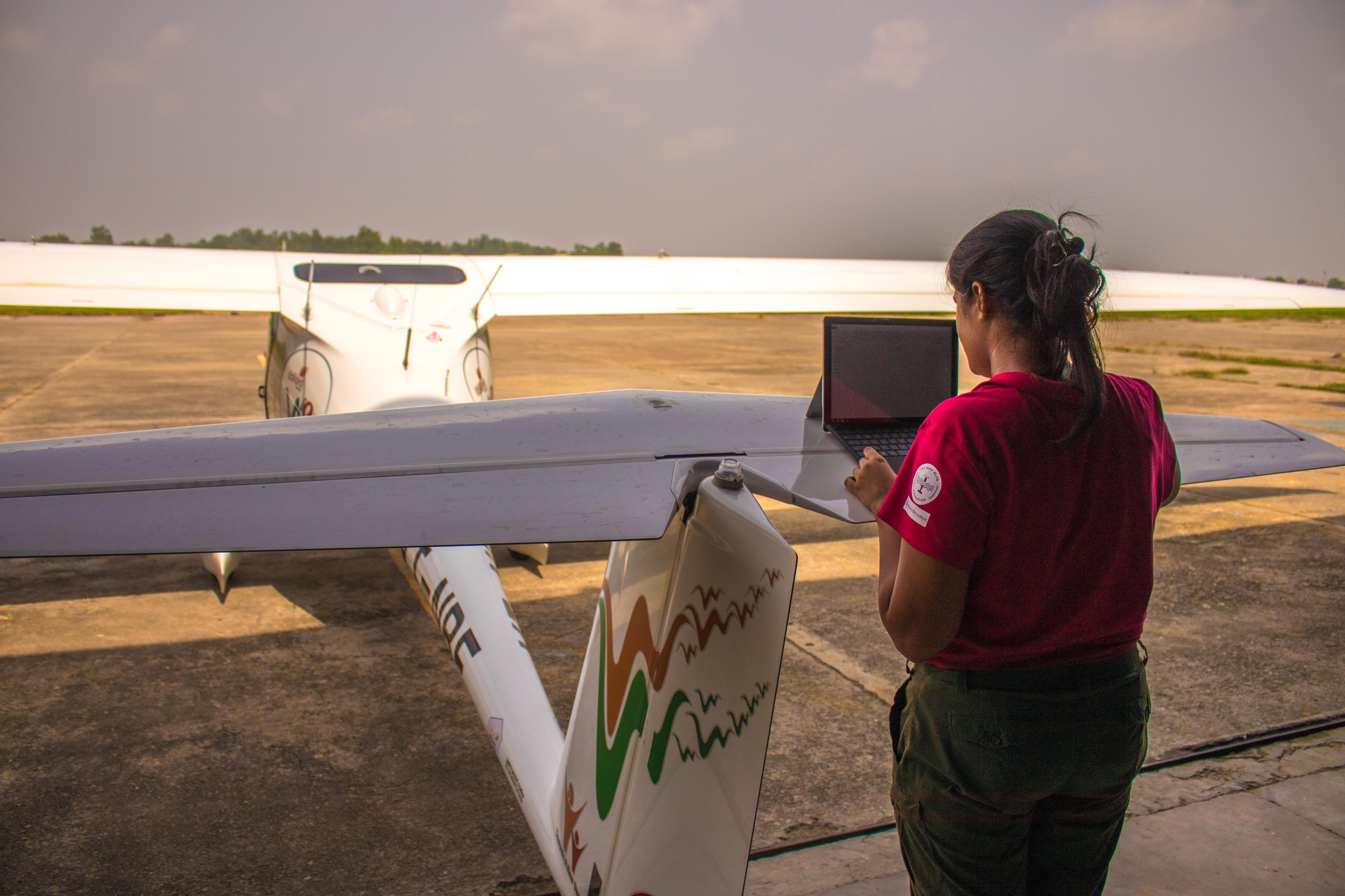 Aarohi Pandit works on the Surface on the rear wing of the motorglider