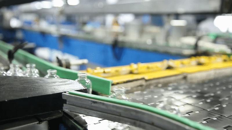 glass bottles moving on a conveyor belt