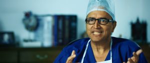 Dr Devi Shetty looking into the camera and smiling