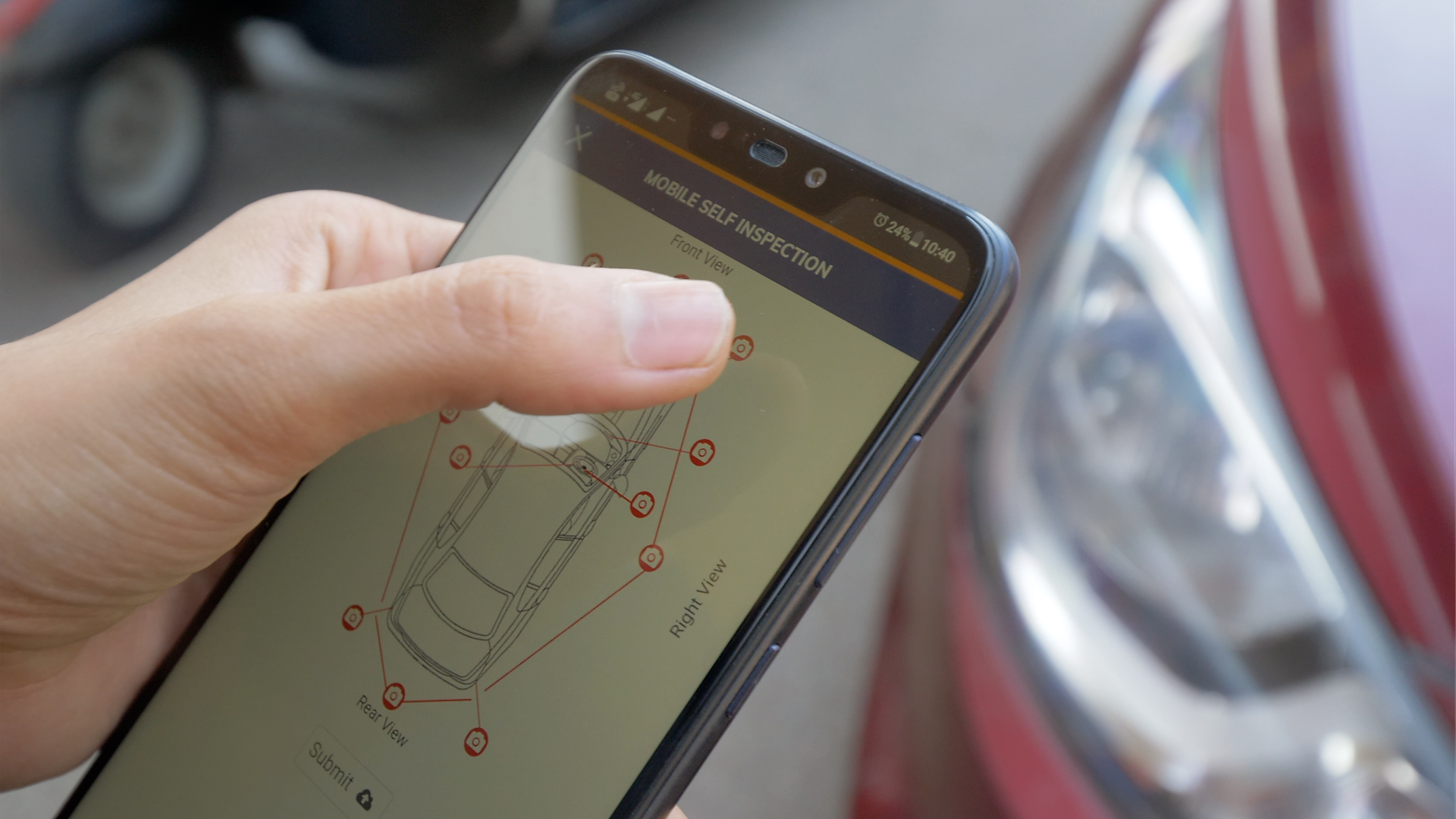 A person self inspecting car insurance through a mobile app
