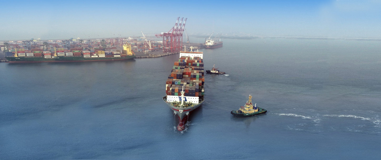 Ships with shipping containers in the middle of the sea at V. O. Chidambaranar Port