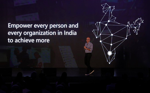 Satya Nadella, CEO of Microsoft, addresses tech leaders and developers at Future Decoded: Tech Summit, Bengaluru. Also seen is the backdrop with the text 'Empower every person and organization in India to achieve more.'