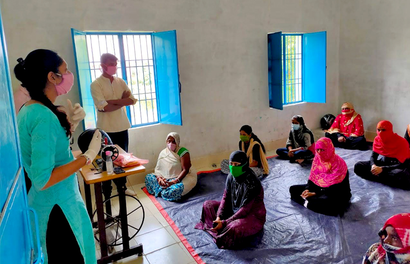 A volunteer from an NGO conducting a training session for women entrepreneurs from rural India on making masks amid the COVID-19 crisis