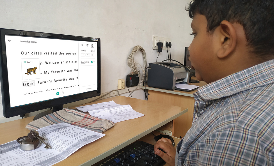 A primary student at Helikx Open school using pictorial dictionary feature of Immersive Reader to read a story.