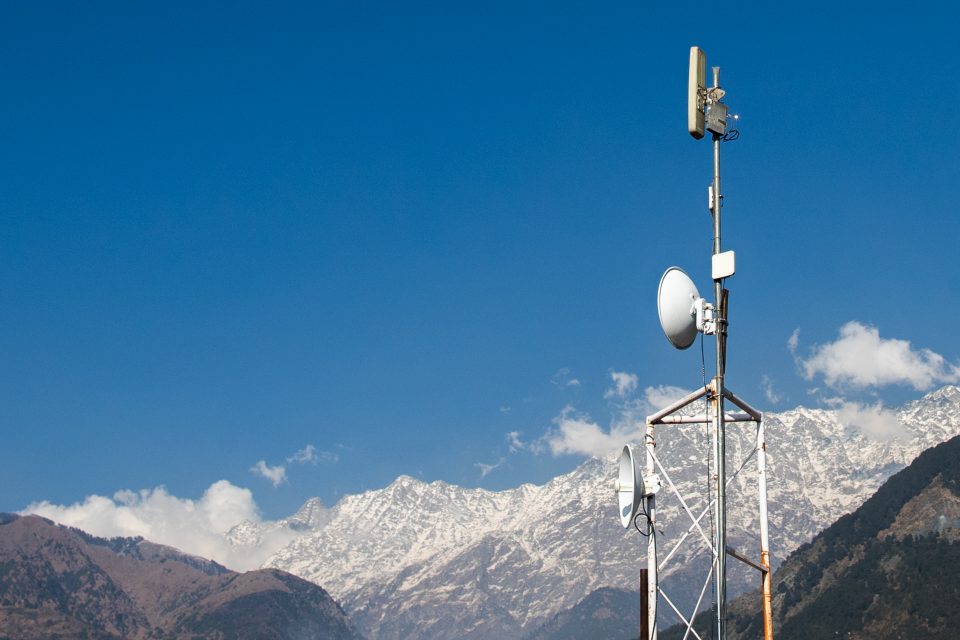Lone relay tower with the Himalayan mountain range in the backdrop