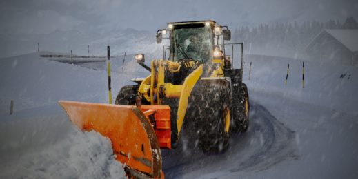 Бульдозер расчищает дорогу после сильного снегопада