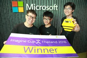 Team of students in front of Microsoft sign holding prize banner as Imagine Cup Thailand winners